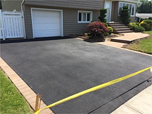 asphalt driveway with golden brown sahara chestnut 6x9 paver border